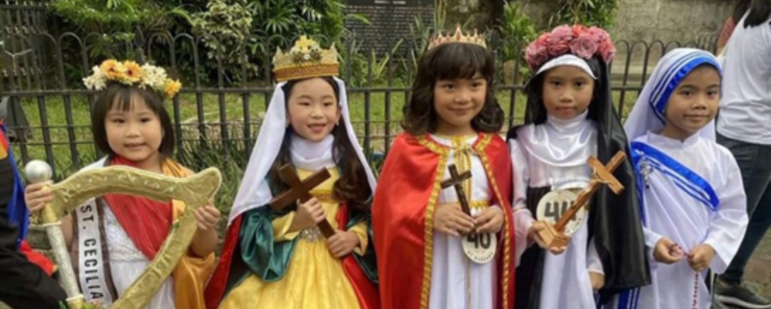 Parade of saints. Adults and children dressed as their favourite saints and martyrs